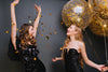 blonde girl in black outfit holding party balloons and looking at friend, Birthday Dinner Outfit Ideas
