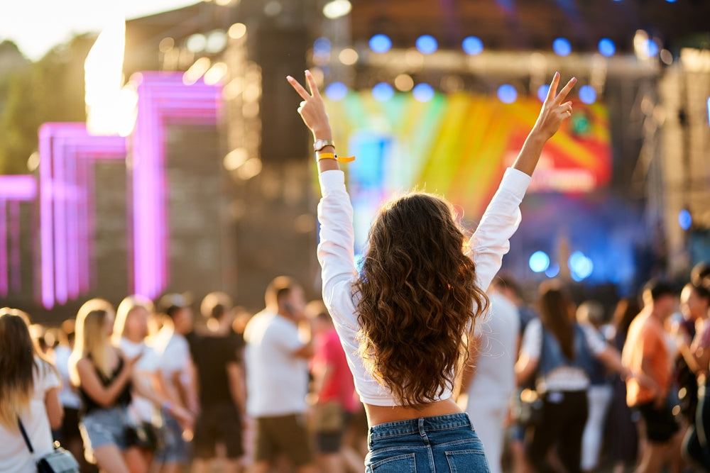 Back view of young woman at summer beach music festival, Music Festival Outfit Ideas
