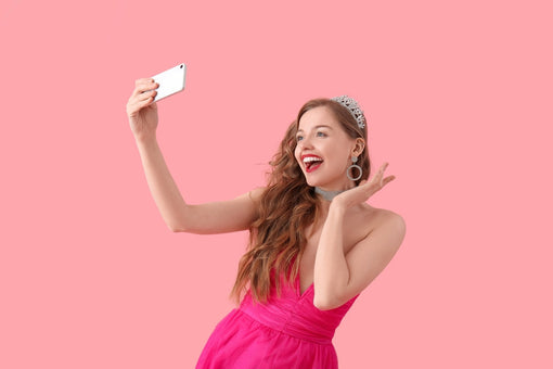 teen girl taking selfie in her prom dress