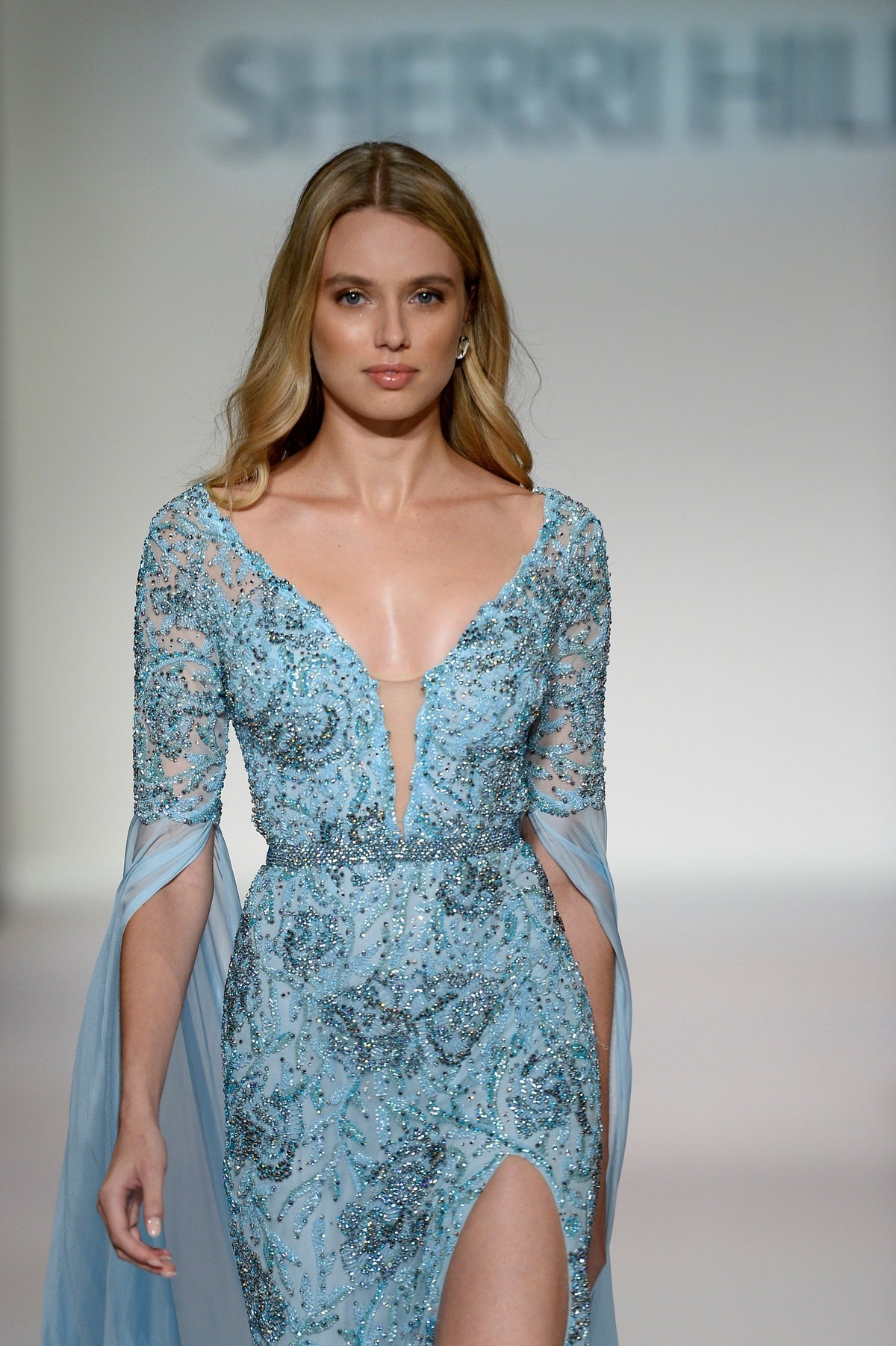 Sherri Hill 44783 V-neck beaded gown with cape sleeves and slit in light blue