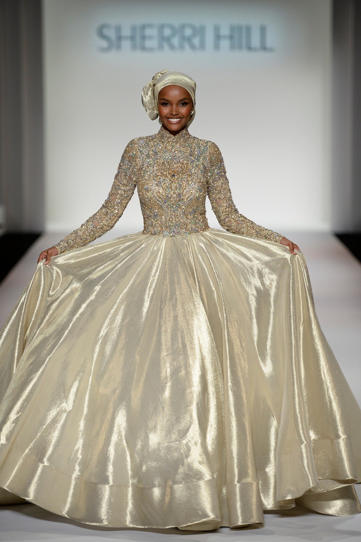 Sherri Hill 44895 long-sleeve metallic ball gown in gold