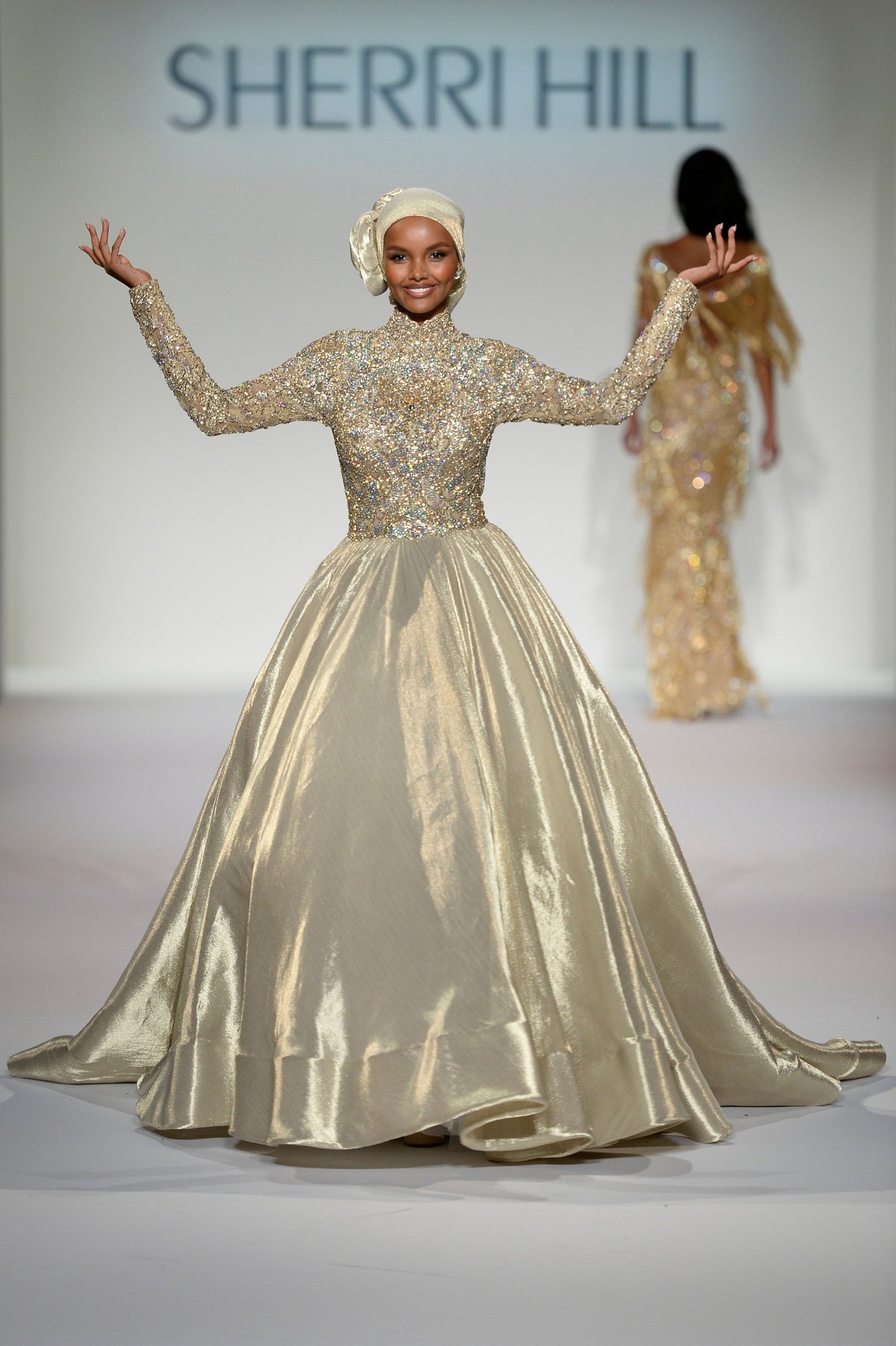 Sherri Hill 44895 long-sleeve metallic ball gown in gold