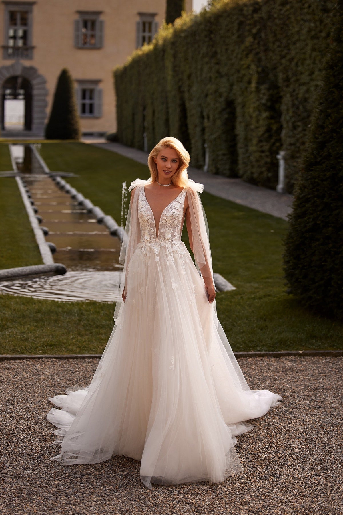 Sherri Hill 81139 V-neck floral appliquéd wedding dress with cape in ivory