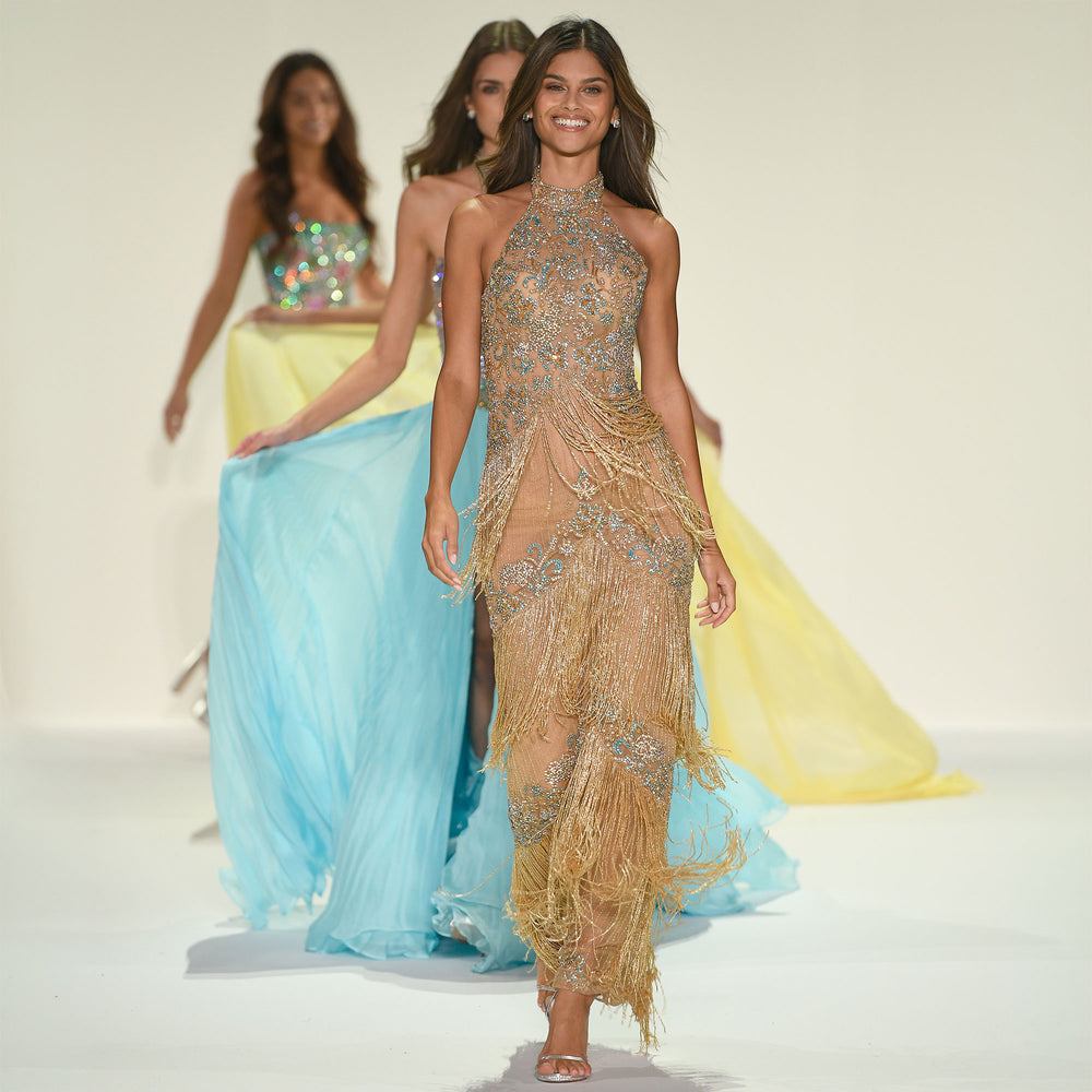 Sherri Hill Spring 2026 finale walk at New York Fashion Week, a gold fringed halter gown with crystal beading