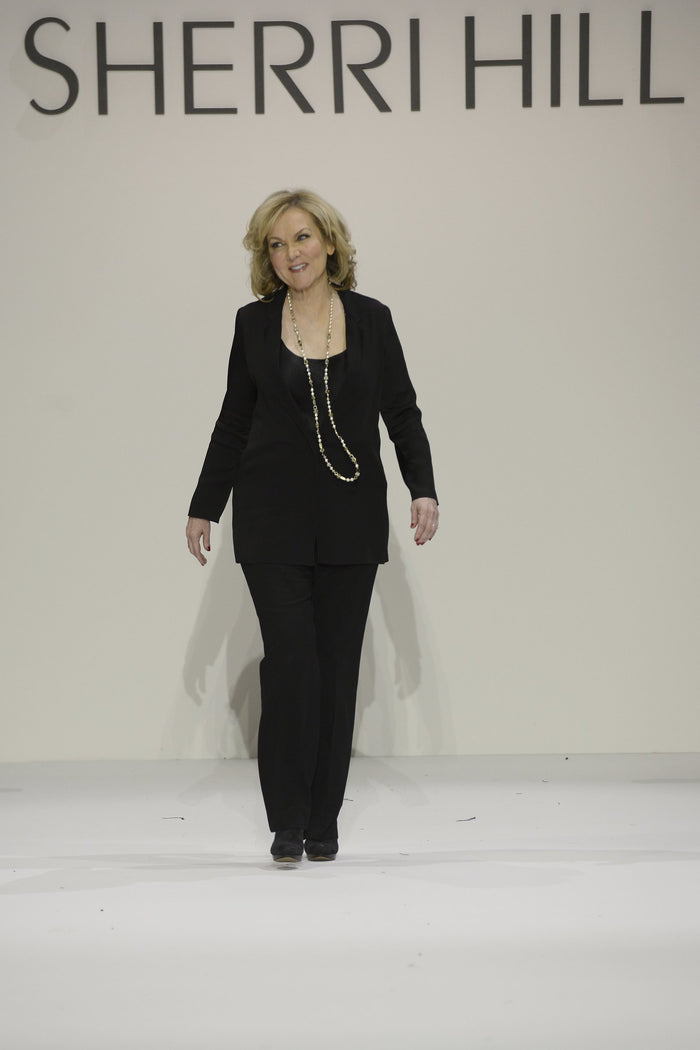 Sherri Hill walks the runway to close the show