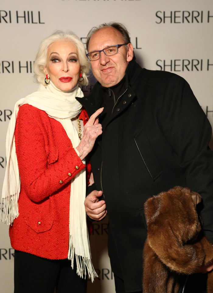 Model Carmen Dell'Orefice and photographer Fadil Berisha on the step-and-repeat before the show