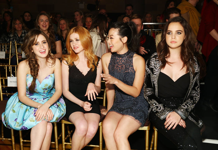 Actress Laura Marano and guests in the front row before the show
