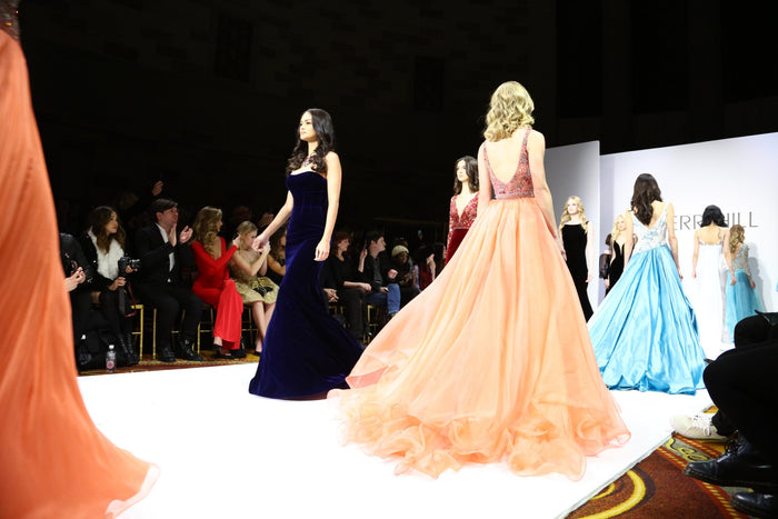 The finale in navy, peach, blue and gold, seen from the front row