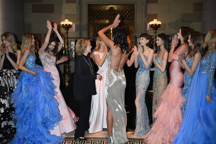 The lineup celebrates backstage after the finale