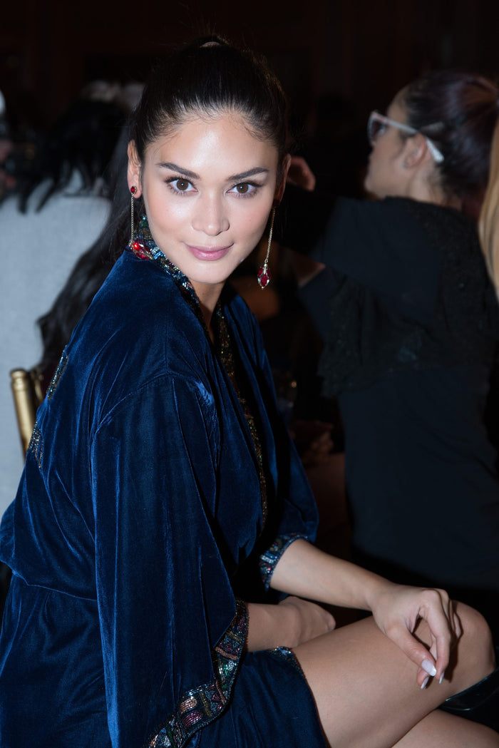 Model Daniela Braga in her blue velvet robe backstage before the show