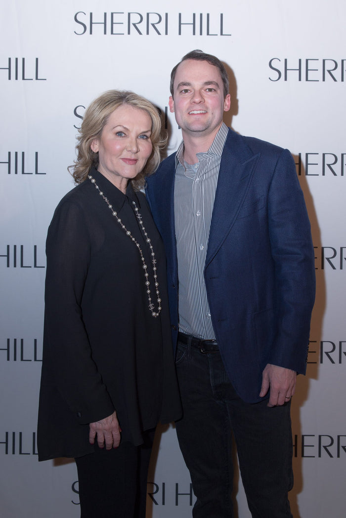Sherri Hill with her son Dusty Hill, President and Co-Founder of Sherri Hill, Inc., on the step-and-repeat