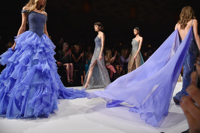 Periwinkle ruffles and a cape on the runway for the finale