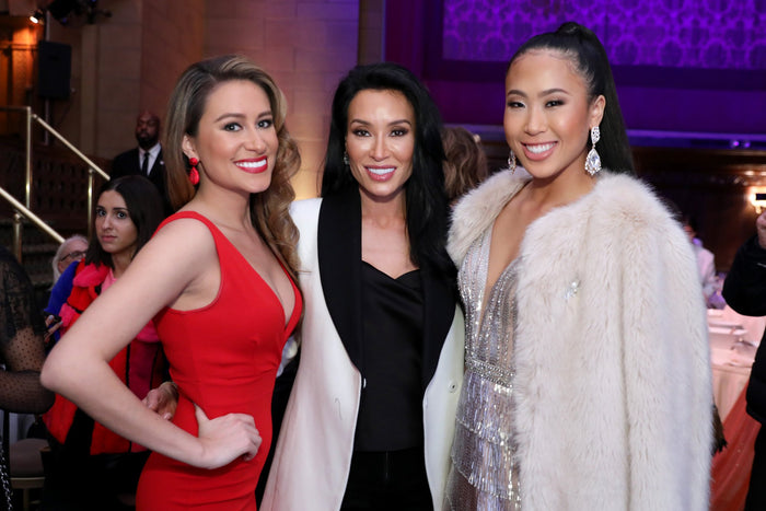 Three guests in red, black and cream at the after party