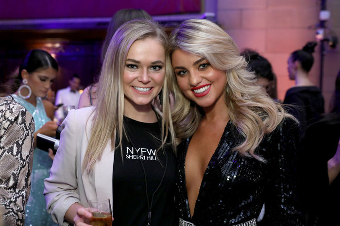 Two guests pose at the after party