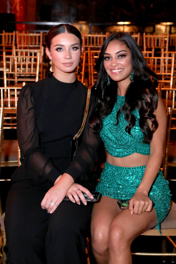 Two guests in black and green sequins