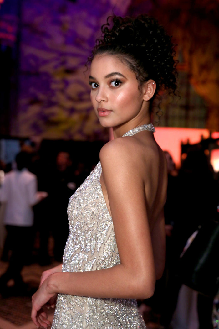 A guest in a silver beaded halter dress at the after party