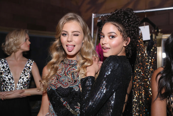 Models in gold and black beaded minis backstage