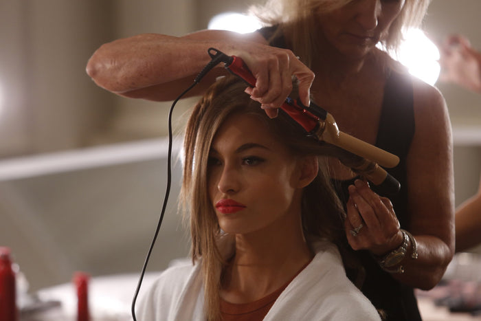 Hair being curled backstage before the show