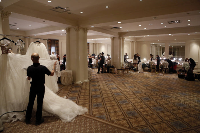 A finale gown is steamed in the ballroom before the show