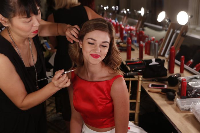 Final touches on hair and makeup backstage