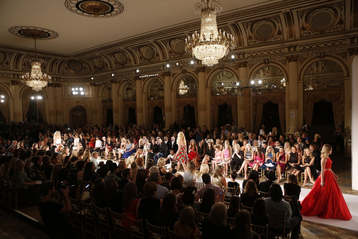 The finale fills the runway under the chandeliers