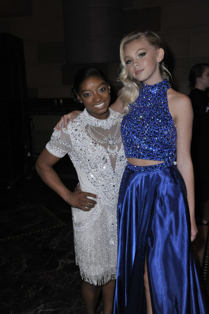 Simone Biles, in a white beaded mini dress, and Jordyn Jones, in a navy sequin two-piece, before the show