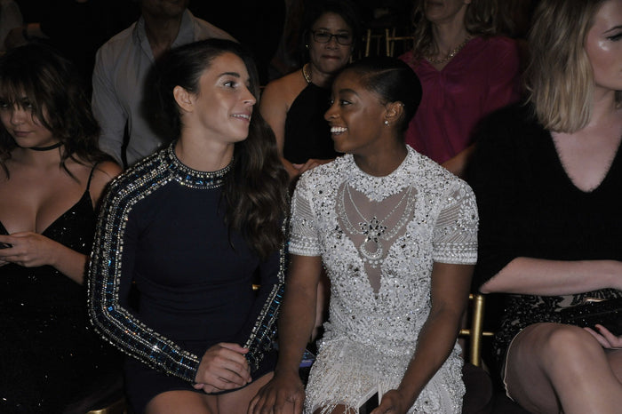Aly Raisman and Simone Biles in the front row before the show at Gotham Hall