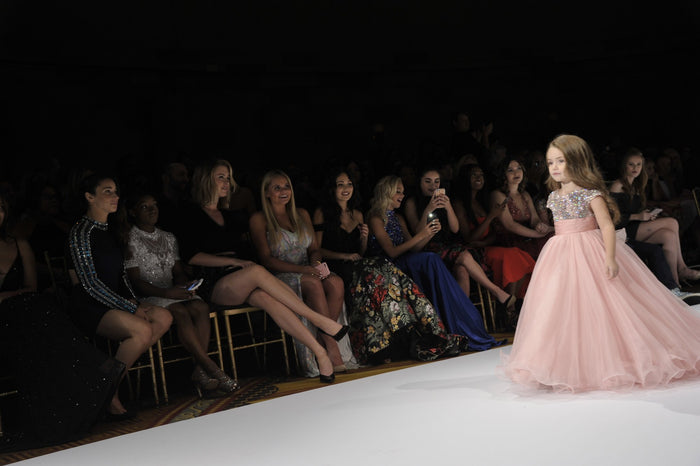 The pink cap-sleeve ballgown on the runway, seen from the front row
