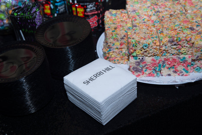 Sherri Hill napkins and a tray of sprinkle-covered treats backstage
