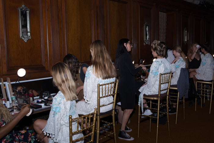 Hair and makeup underway in the wood-panelled room backstage at Gotham Hall