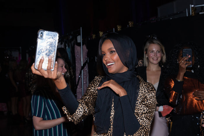 Model Halima Aden takes a selfie backstage before the show