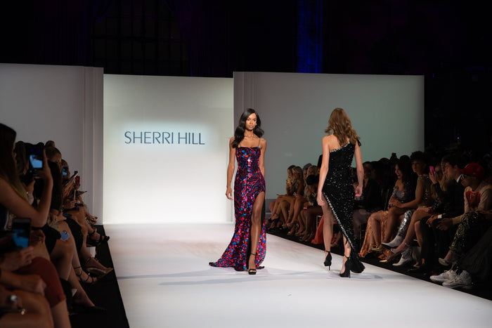 A mirrored mini dress and a black one-shoulder gown on the runway