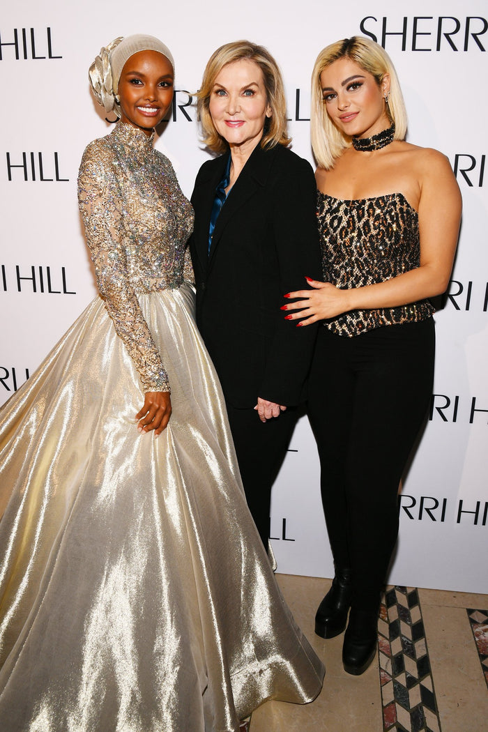Halima Aden and Bebe Rexha pose with Sherri Hill on the red carpet