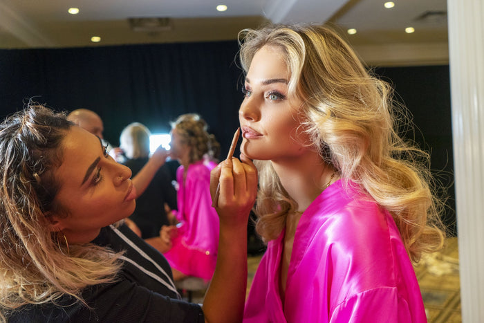 Makeup being finished backstage before the show