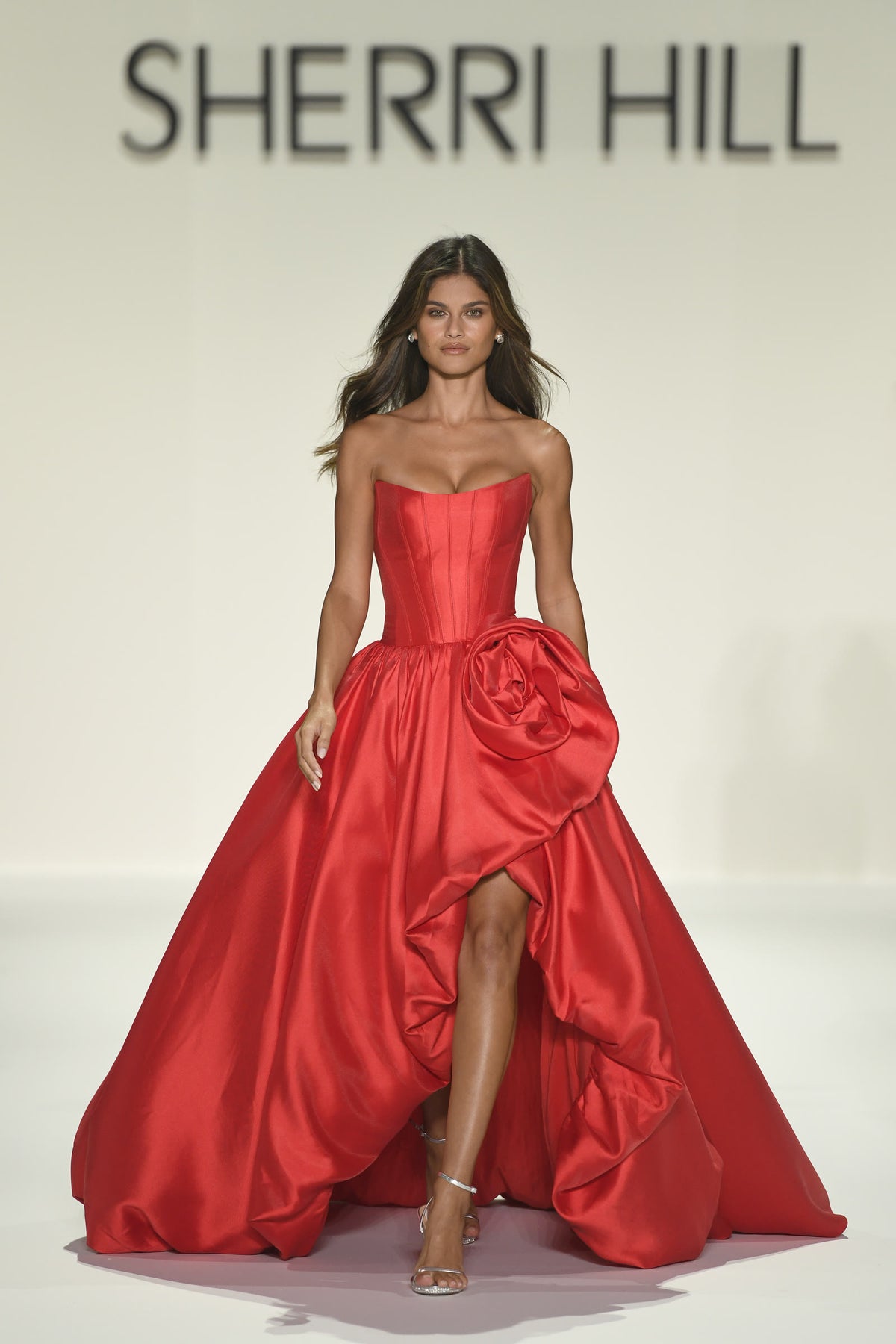 A red strapless ballgown with a rose at the bodice on the Sherri Hill Spring 2026 runway